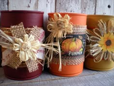 four jars with pumpkins and burlocks on them