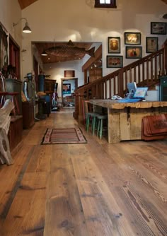 the inside of a house with wood floors and pictures on the wall