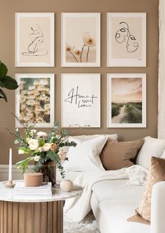 a living room filled with lots of pictures on the wall above a white couch and coffee table