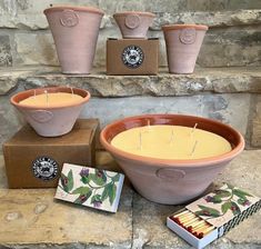 candles are sitting on top of boxes next to potted planters and other items