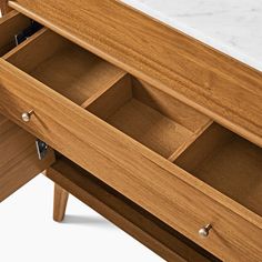 a wooden dresser with drawers and marble top