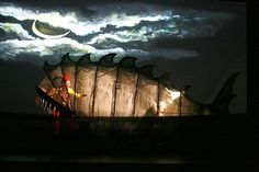 an image of a dragon on display in the dark