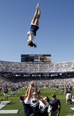 a person doing a handstand at a football game