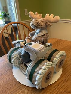 a stuffed moose riding on top of a toy car