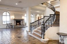 a large open floor plan with stairs leading up to the second story and another room in the background