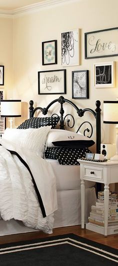 a bedroom with black and white decor on the walls