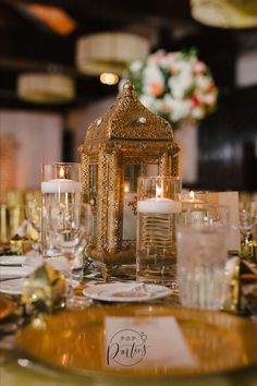 a fancy table setting with candles and plates