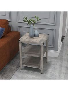 a living room with a brown couch and two vases on top of the table