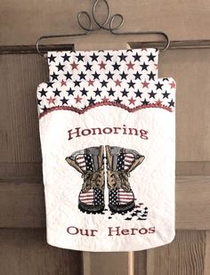 a patriotic banner hanging on a door with the words honoring our hero written in red, white and blue stars