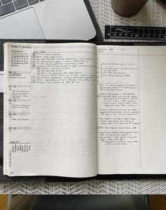 an open notebook sitting on top of a table next to a computer keyboard and mouse