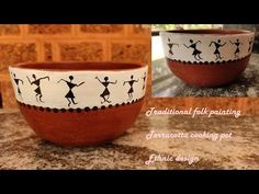 two bowls sitting on top of a counter with designs painted on the bottom and sides