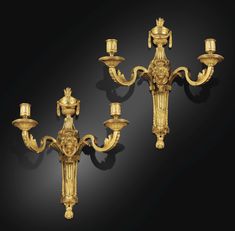 two gold - plated candelabras, possibly from the 19th century