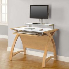 a computer desk with a monitor and keyboard on it