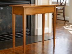 a wooden table sitting in front of a fireplace