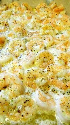 a casserole dish with shrimp and cheese on it, ready to be eaten