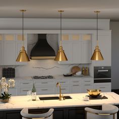 a large kitchen with white cabinets and gold pendant lights hanging from the ceiling over the island