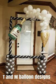 an arch made out of balloons and champagne bottles