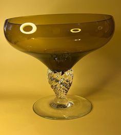 an upside down glass vase sitting on top of a yellow tablecloth covered flooring