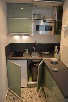 small kitchen with sink, dishwasher and microwave in it's cupboards