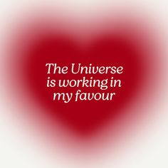 the universe is working in my favour quote on red and white heart background