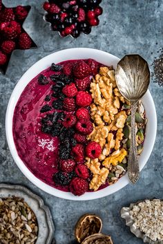 a bowl filled with cereal, berries and nuts