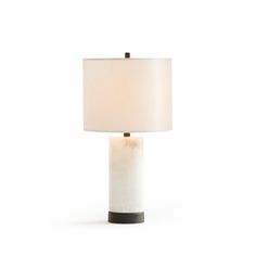 a table lamp with a white shade on it's base and a black metal base