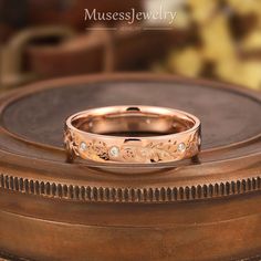 a close up of a wedding ring on top of a table