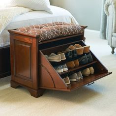 a wooden shoe rack with several pairs of shoes in it