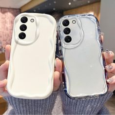 two people holding up their cell phones in front of the same phone case with buttons on them