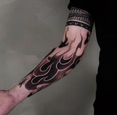 a man's arm covered in black and white tattoos