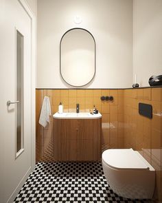 a bathroom with black and white checkered flooring, a round mirror above the toilet