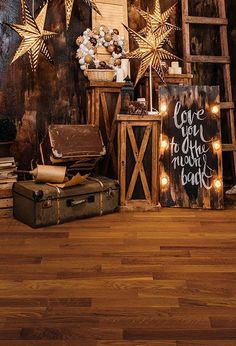 an old suitcase is sitting on the floor in front of a wooden ladder and christmas decorations