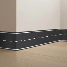 an empty room with black and white lines painted on the wall next to wood flooring