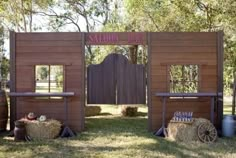 an outdoor bar with hay bales and barrels