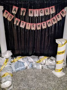 there is a birthday banner on the wall next to some plastic bags and tape wrapped around it