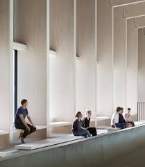 several people sitting on benches in a building