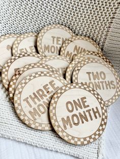 there are six wooden buttons that say three months, two month and one month on them