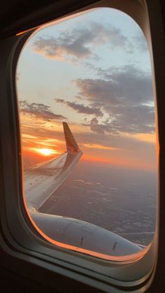 the view from an airplane window at sunset