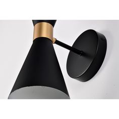 a black and gold wall light on a white background