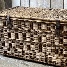 a large wicker basket sitting on top of a wooden floor