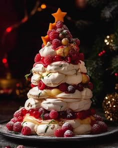 a christmas tree made out of meringue and raspberries on a plate