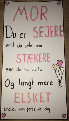 a sign with words written in pink and black on it, including two hearts attached to the back