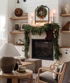 a living room filled with furniture and a fire place covered in greenery next to a fireplace