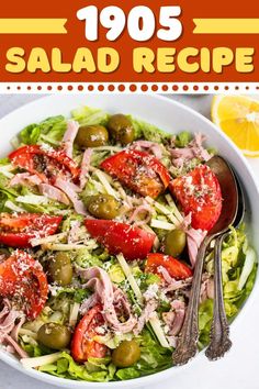 a salad with tomatoes, olives and cheese in a white bowl on top of a table