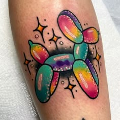 a colorful tattoo on the leg of a person with stars around it and an image of a turtle