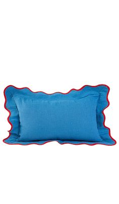 a blue and red pillow with scalloped edges