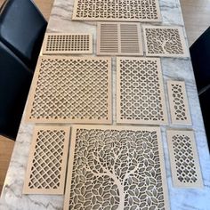 the table is covered with intricately designed floor mats and placemats, which have been cut out to look like a tree