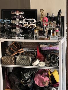 a white shelf filled with lots of purses and handbags on top of it