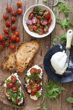 bread with tomatoes, mozzarella and lettuce on it next to other food items