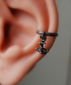 "Sailors Anchor Ear cuff - Nautical jewelry - Pierced - Non-pierced - Dark Anchor Earrings - Sterling Anchor Earrings - Captains gift - For your Pirate Sailor- Small sterling silver anchor in a conch cuff. You will love the detail in this and will be a special gift to your sailor.   I darken the sterling to look like iron but I can leave it shiny. Note that the model in the video is 30% larger than a normal man's ear.  The cuff in the video is a Large Sz 1/2\" ID Sizes available are 3/8\" (10mm) Dark Pirate, Persona Oc, Pirate Earrings, Pirate Anchor, Conch Cuff, Captain Gifts, Anchor Jewelry, Anchor Earrings, Anchor Pendant